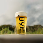 Pint of beer from 360 Brewing Company on a wooden surface with a blurred natural background